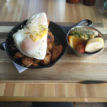 Monki Breakfastclub & Bistro - Brisket & Pork Sausage Hash topped with eggs and hollandaise. - Breakfast & Brunch Near Me - Calgary, Alberta