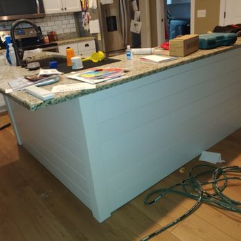 Mavericks Remodeling - Wood slat kitchen island install - General Contractors Near Me