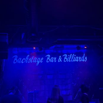 Backstage Bar & Billiards - Stage and sign. Not surprised there's not a lot of people here. It smells nasty and super smoky - Bars Near Me - Las Vegas, Nevada