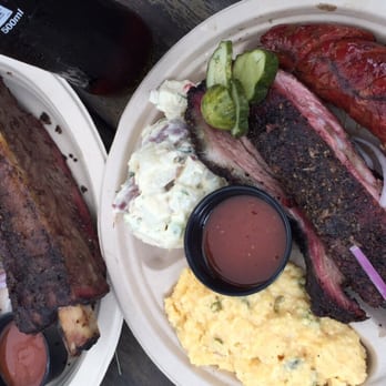 Micklethwait Craft Meats - Beef rib (left) and three meat plate (lamb sausage, pork rib, brisket, cheese grits, potato salad) - Food Trucks Near Me - Austin, Texas