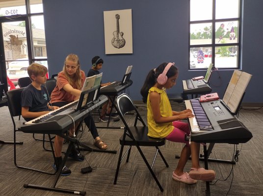 Group Piano Lessons - Explore the world of music together with Musicians in Motion's distinctive group piano lessons! Designed for ages 6 and up, our unique approach enables students of varying levels to learn side by side, creating a collaborative and supportive environment. Whether you're a beginner or have some piano experience, these group classes offer a dynamic setting to enhance your skills. Current private students seeking additional support are warmly welcomed to join our group sessions at a discounted rate. At Musicians in Motion, we believe that the joy of music should be shared and experienced together. Join our group piano classes and embark on a harmonious journey of learning and creativity! Group Piano Lessons - Explore the world of music together with Musicians in Motion's distinctive group piano lessons! Designed for ages 6 and up, our unique approach enables students of varying levels to learn side by side, creating a collaborative and supportive environment. Whether you're a beginner or have some piano experience, these group classes offer a dynamic setting to enhance your skills. Current private students seeking additional support are warmly welcomed to join our group sessions at a discounted rate. At Musicians in Motion, we believe that the joy of music should be shared and experienced together. Join our group piano classes and embark on a harmonious journey of learning and creativity!