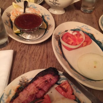 Peter Luger - thick pain fried bacons w side sweet onionss and tomatoooes. Dont forget dipped w thier peterL home made steak sause. Yuummyy - Steakhouses Near Me - Brooklyn, New York