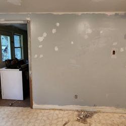 207 Renovations - Fixing trim and patching holes in drywall prior to painting.