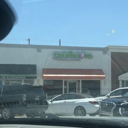 a truck and a car in front of a store