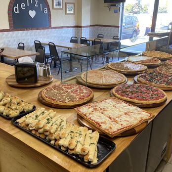 Delizia Pizza - a variety of pizzas on a table - Pizza Near Me - Doylestown, Pennsylvania Delizia Pizza - a variety of pizzas on a table - Pizza Near Me - Doylestown, Pennsylvania