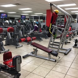 Bench, pull-up/dip station behind cardio machines