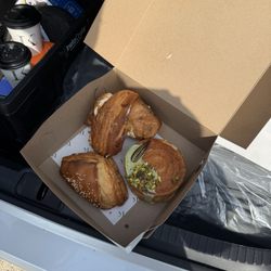 Iron Kettle Conmissary - Two coffees, starting at the top and going clockwise; peach cobbler cruffin, pistachio croissant, spinach turnover.