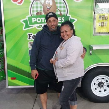 Stuffed Potatoes - a man and woman standing in front of a food truck - Food Trucks Near Me - Palm Bay, Florida