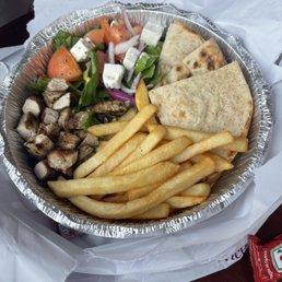 a plate of french fries and a salad a plate of french fries and a salad