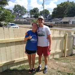 YoungLife Construction & Demolition - My husband and I in front of our new privacy fence!!