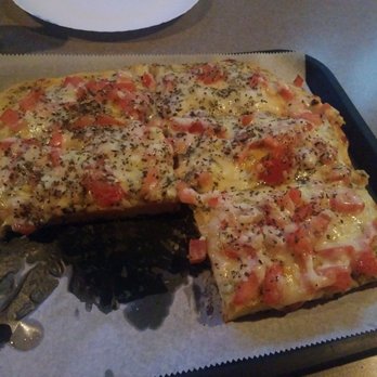 Finn's Cafe 99 - a pizza with a slice taken out of it - Cafes Near Me - Wilkes Barre, Pennsylvania