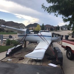 Keep It Moving - Keep It Moving securing a small two seat plane onto a trailer to be transported to another location nearby in New Orleans, LA. - Movers Near Me - Slidell, Louisiana