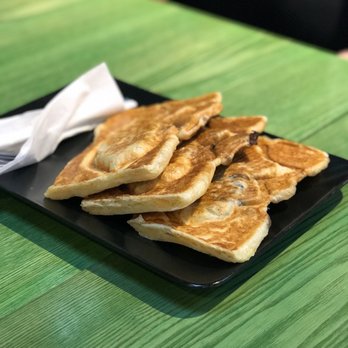 Snowy Village - a plate of pancakes on a table - Desserts Near Me - Coquitlam, British Columbia Snowy Village - a plate of pancakes on a table - Desserts Near Me - Coquitlam, British Columbia