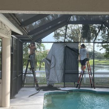 Re-screen Renovations - two men installing a screen in a pool - Painters Near Me - Sarasota, Florida