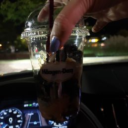 a hand holding a cup of coffee a hand holding a cup of coffee