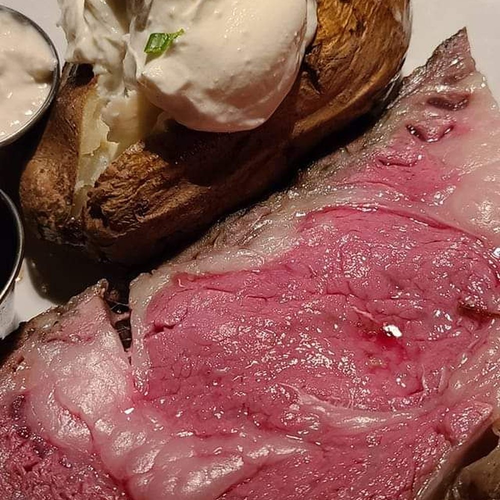 Feeney's Restaurant and Bar - Medium rare Prime Rib with a loaded baked potato and what's left of a strong old fashioned. - Bars Near Me - Phoenix, Arizona