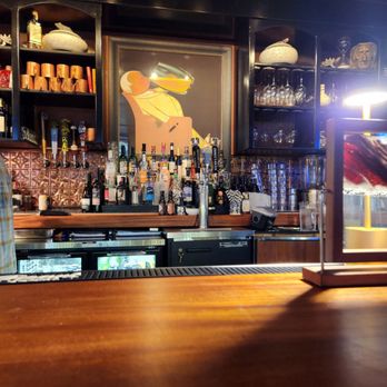 Finicky Franks - a wooden bar with bottles of alcohol - American Near Me - Omaha, Nebraska Finicky Franks - a wooden bar with bottles of alcohol - American Near Me - Omaha, Nebraska