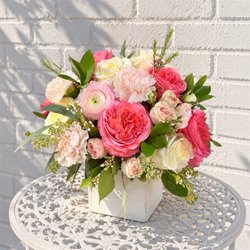 Eufloria Florist - Blush Garden arrangement featuring Pink Xpression roses, Candlelight roses, blush ranunculus, and other blooms and greenery in a wooden cube