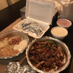 Rey San Jose - Chicken & steak fajitas, sides of rice & beans, pico de gallo, cheese dip, salsa, side of tacos.