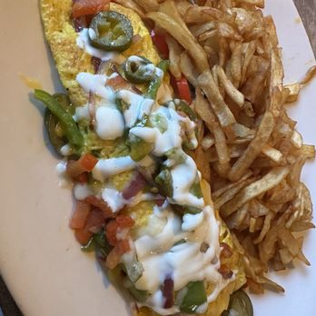 Toast Kitchen & Bar - Spanish Omelette $19 Red and green bell peppers, tomato, onion, jalapeño, monterey jack, cheddar, sour cream - Breakfast & Brunch Near Me - Brea, California