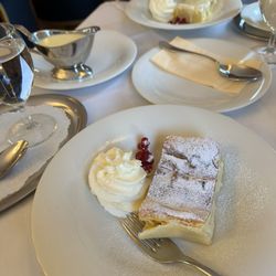 Schlosscafe - Creamy strudel cake with vanilla sauce on the side.