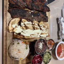 Mi Bella Honduras - Riblets grill plate with rice,  fried banana, beans, pickled onion, guacamole, pico de gallo, salsa and tortillas $18