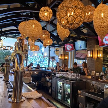 Barrio - people sitting at a bar in a restaurant - Cocktail Bars Near Me - West Palm Beach, Florida Barrio - people sitting at a bar in a restaurant - Cocktail Bars Near Me - West Palm Beach, Florida