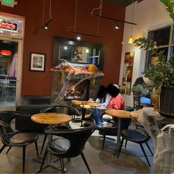 Urban City Coffee - Cozy fire and places to sit. There are also tables and a window bar at the opposite side of the cafe.