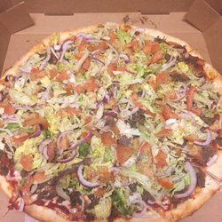 Crazy Cow Steak and Pizza - Our Taco Pizza! This is on a regular cheese pie with steak, lettuce, onion and tomato