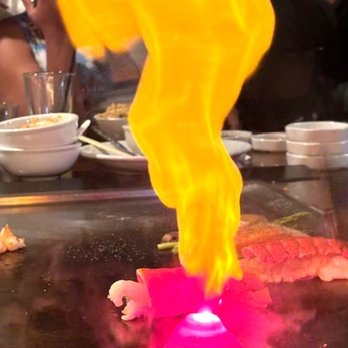 Benihana - San Francisco - Chef cooking a pile of onions that he shaped into a pyramid before lilting the fire. - Teppanyaki Near Me - San Francisco, California Benihana - San Francisco - Chef cooking a pile of onions that he shaped into a pyramid before lilting the fire. - Teppanyaki Near Me - San Francisco, California