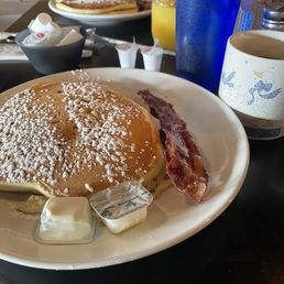 Two orders of Pancakes and bacon, with coffee and orange juice. Two orders of Pancakes and bacon, with coffee and orange juice.
