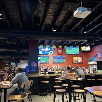 Buffalo Wild Wings - a man sitting at a bar - Chicken Wings Near Me - Lincoln, Nebraska Buffalo Wild Wings - a man sitting at a bar - Chicken Wings Near Me - Lincoln, Nebraska