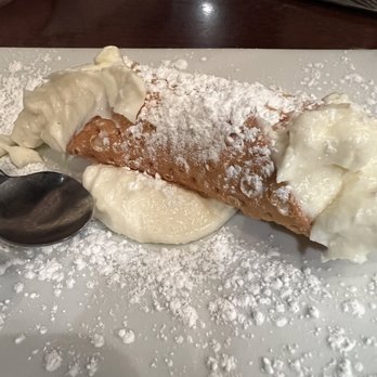 Caffé Italia - a pastry with powdered sugar and a spoon - Italian Near Me - Marblehead, Massachusetts