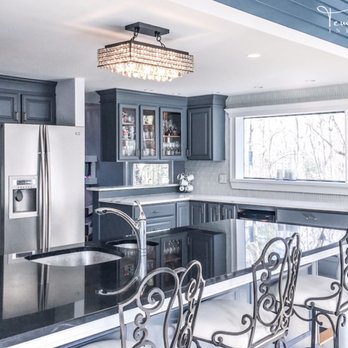 Tempting Interiors - Glam kitchen redesign. Cabinet refinish, quartz countertops and glass backsplash, new hardware and crystal lighting. - Interior Design Near Me