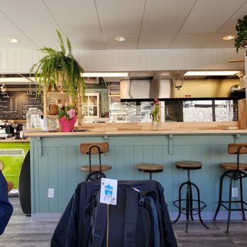 EPICanmore - a man sitting at a table in a restaurant - Creperies Near Me - Canmore, Alberta