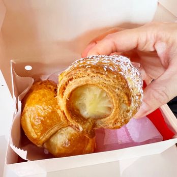 Palmieri Cafe - a person taking a pastry out of a box - Coffee & Tea Near Me - Dallas, Texas Palmieri Cafe - a person taking a pastry out of a box - Coffee & Tea Near Me - Dallas, Texas
