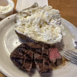 6 oz. filet cooked medium with a baked potato with butter and sour cream.