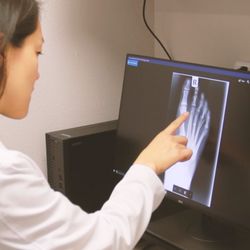 Sound Foot and Ankle - Dr. Joyce examining an x-ray to provide a patient with a pain solution.