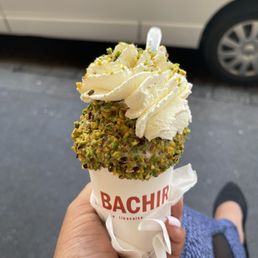 Rose ice cream and the special ice cream of the day with whip cream  on top and pistachios delicious
