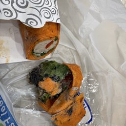 a sandwich wrapped in plastic wrap