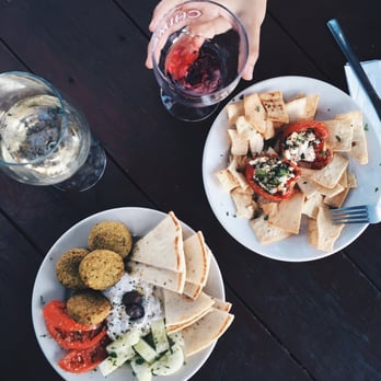 Opa! Greek Cafe - Falafel and stuffed tomato plate. Sauv blanc and sangria, to which they add sprite - Wine Bars Near Me - Austin, Texas