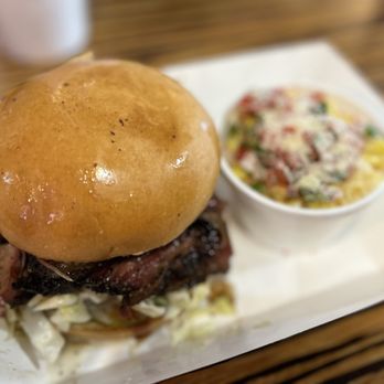 Koop's BBQ Kitchen & Catering - Sliced Brisket on Brioche Bun with Spicy Jalapeno cream Corn - Barbeque Near Me - Galveston, Texas Koop's BBQ Kitchen & Catering - Sliced Brisket on Brioche Bun with Spicy Jalapeno cream Corn - Barbeque Near Me - Galveston, Texas