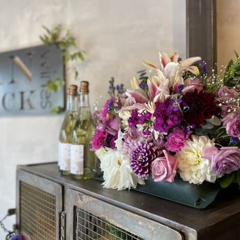 Milbrandt Vineyards - a display of flowers and bottles of wine - Wine Tasting Room Near Me - Leavenworth, Washington Milbrandt Vineyards - a display of flowers and bottles of wine - Wine Tasting Room Near Me - Leavenworth, Washington