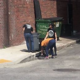 Employees dumping what is apparently waste water from cleaning grease traps into our harbor via storm drains.