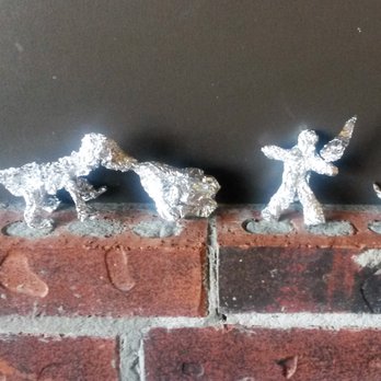 Freebirds World Burrito - Aw, that's cool...someone left foil figurines on the sideboard.  Looks like a fire-breathing dragon up against a sword-wielding knight! - Mexican Near Me - Austin, Texas