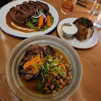 Cindy's Rooftop - Pork shoulder and steak, along with a baked potato - New American Near Me - Chicago, Illinois Cindy's Rooftop - Pork shoulder and steak, along with a baked potato - New American Near Me - Chicago, Illinois