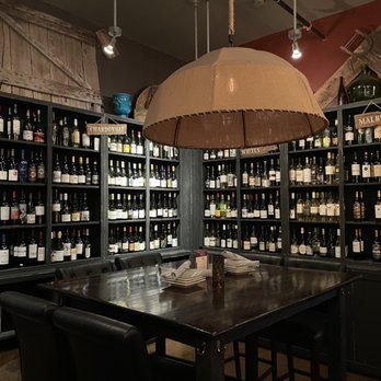 The Wine Bistro - a table and chairs in a wine cellar - Wine Bars Near Me - Upper Arlington, Ohio