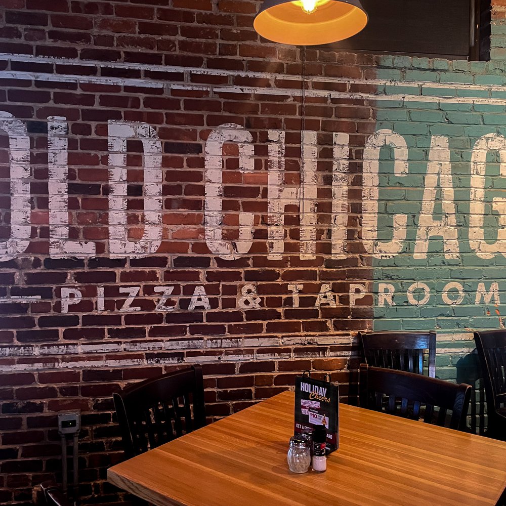 Old Chicago Pizza + Taproom - a brick wall in a restaurant - Pizza Near Me - Columbia, South Carolina Old Chicago Pizza + Taproom - a brick wall in a restaurant - Pizza Near Me - Columbia, South Carolina