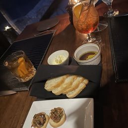 Bread and nightly pairing of crostini with olive tapenade. Bread and nightly pairing of crostini with olive tapenade.