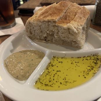 Paesanos 1604 - Warm bread with olive oil and tapenade - Italian Near Me - San Antonio, Texas Paesanos 1604 - Warm bread with olive oil and tapenade - Italian Near Me - San Antonio, Texas